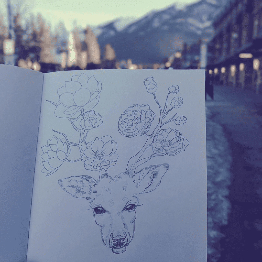 A pencil drawing of a deer with flowers branching out as it's antlers